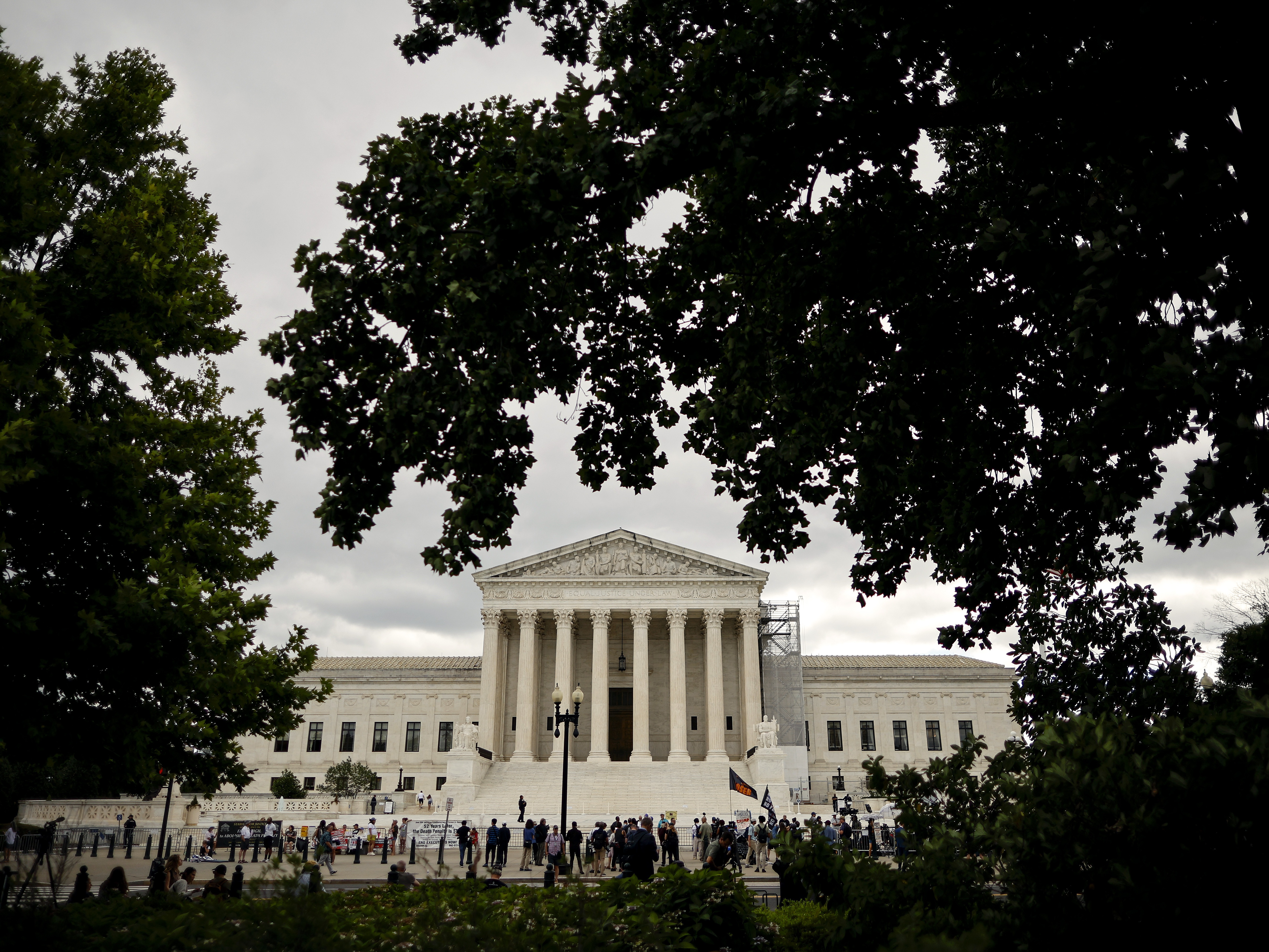 caption: People gather outside the U.S. Supreme Court.