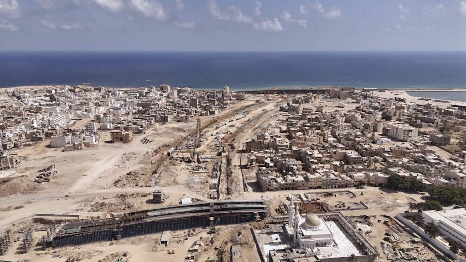caption: An aerial shot shows bridge construction in the city of Derna, Libya on Sept. 7, 2024. (Muhammad Elalwany/AP)