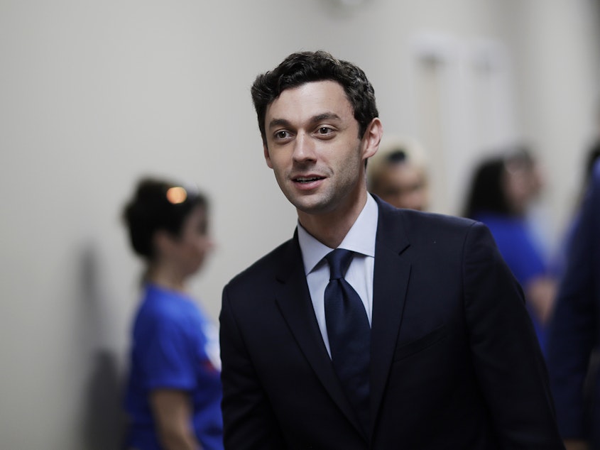 caption: Jon Ossoff leaves a campaign office in 2017 after meeting with supporters in Marietta, Ga. Ossoff lost a special election that year to fill the seat in Georgia's 6th Congressional District.