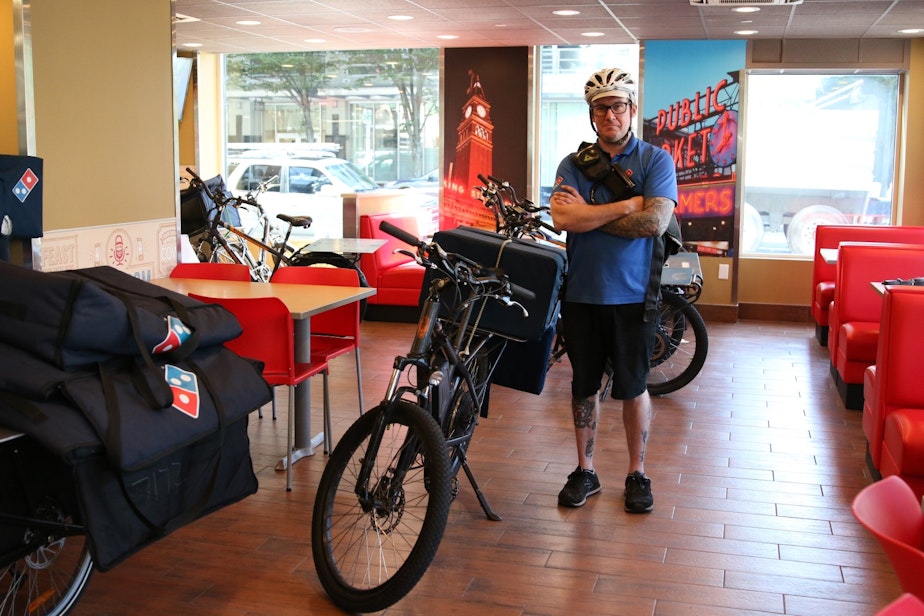caption: Nick Knudtson delivers pizzas by bike at the Belltown Domino's