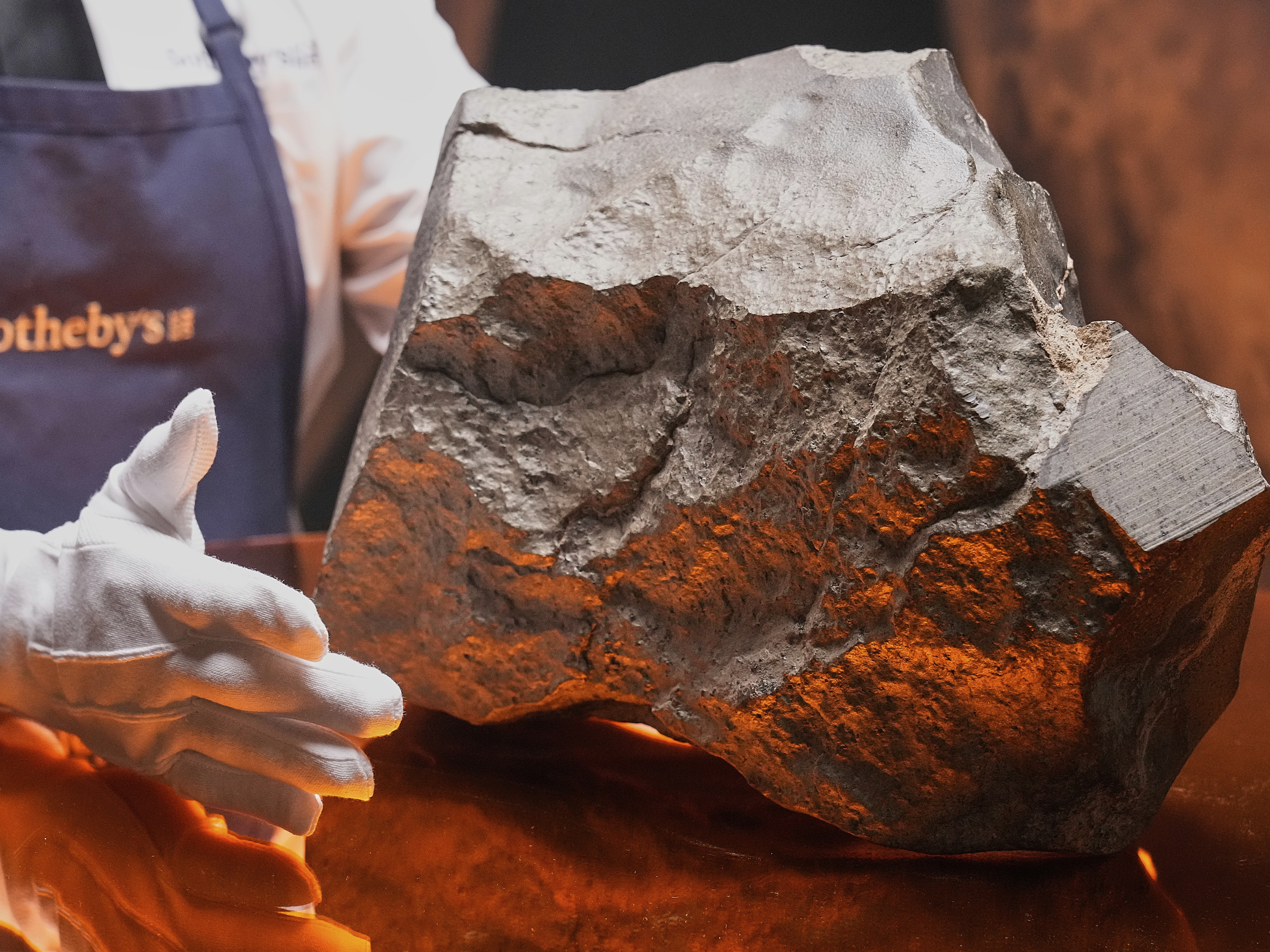 caption: A Martian meteorite said to be the largest piece of Mars on Earth, estimated at $2 - 4 million, is displayed at Sotheby's, in New York.