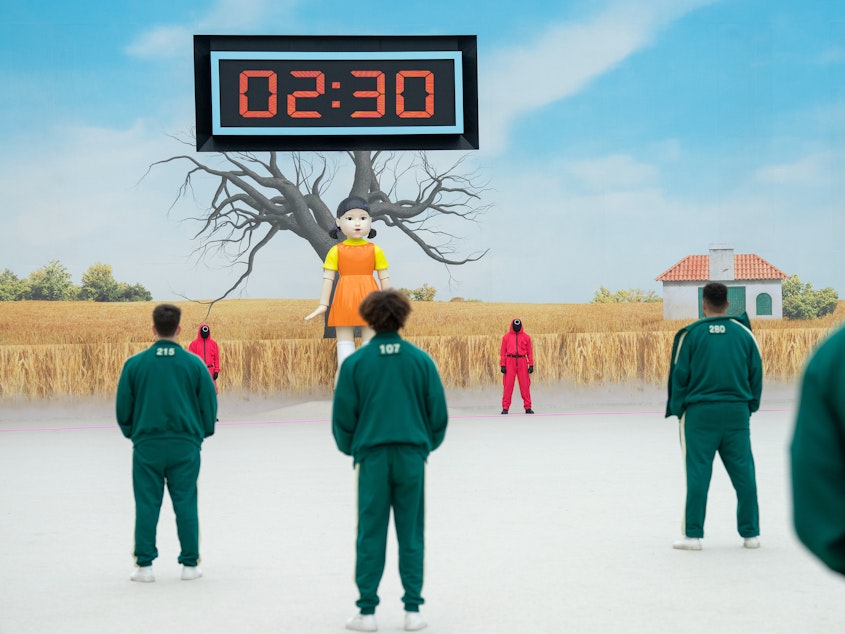 caption: A U.K.-based law firm said at least two contestants felt "unwell" after standing for hours in cold temperatures during a taping for <em>Squid Game: The Challenge. </em>The reality competition was inspired by the hit South Korean drama.
