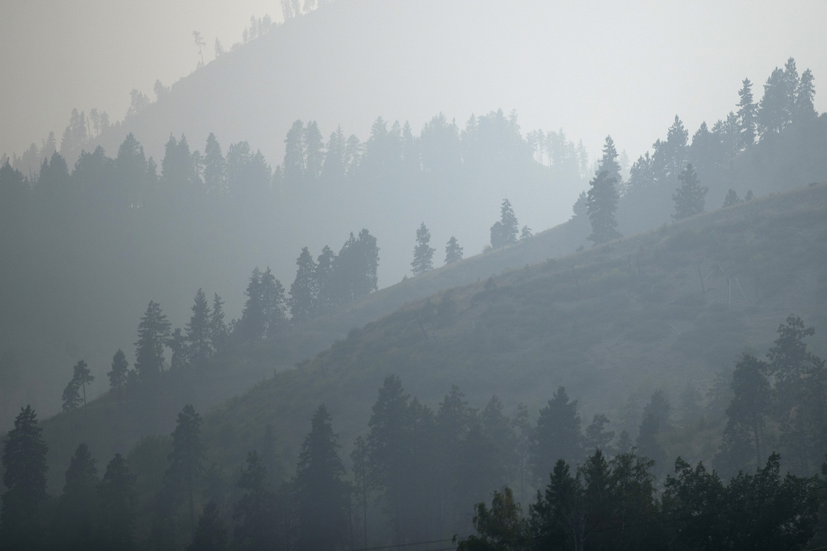 caption: Heavy smoke from wildfires is shown on Wednesday, August 15, 2018, outside of Wenatchee.