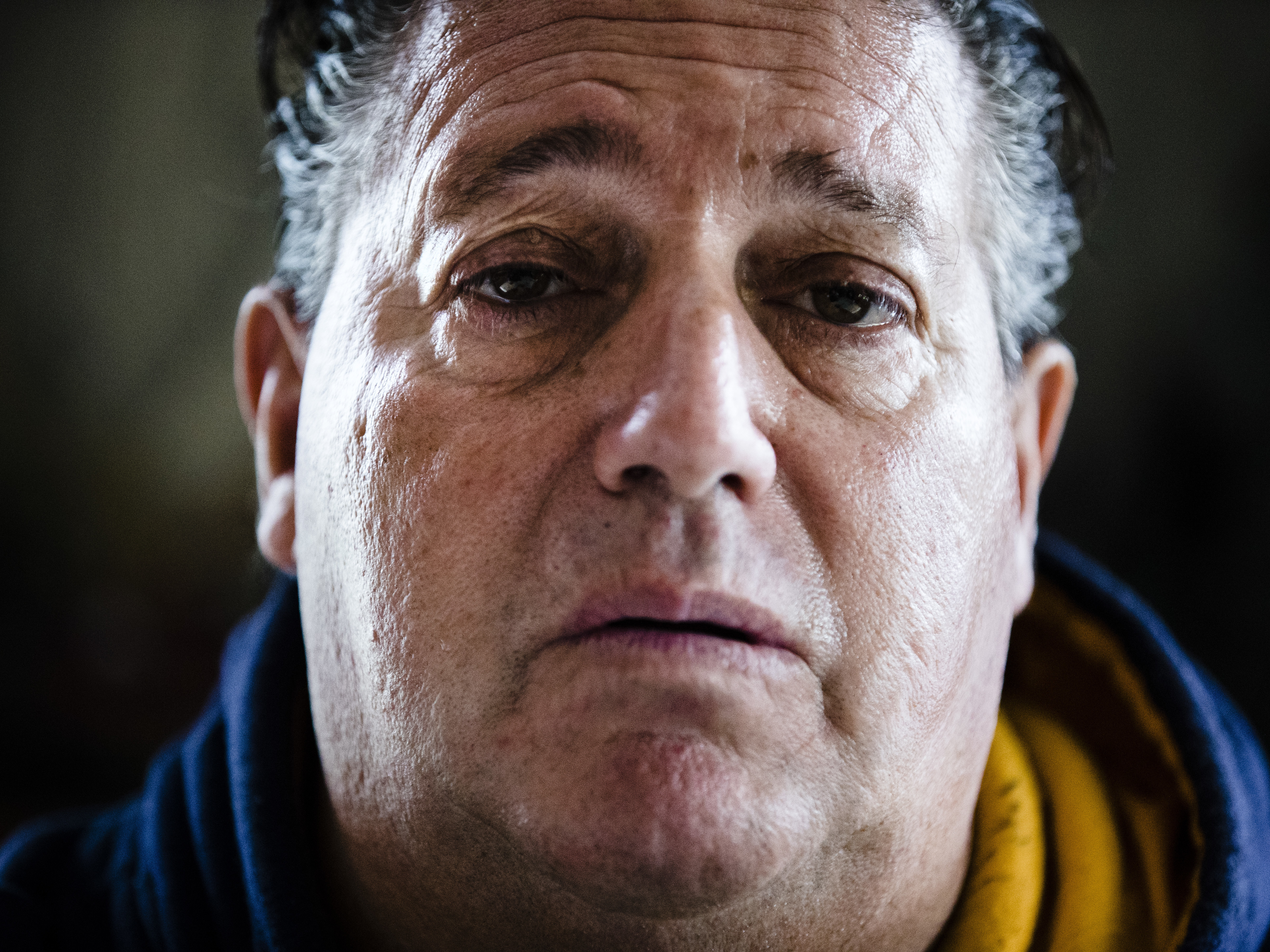 caption: Anthony Torres poses for a photograph at his brother's home in Atco, N.J., after revealing he was the man caught in a viral video shaving on a train.