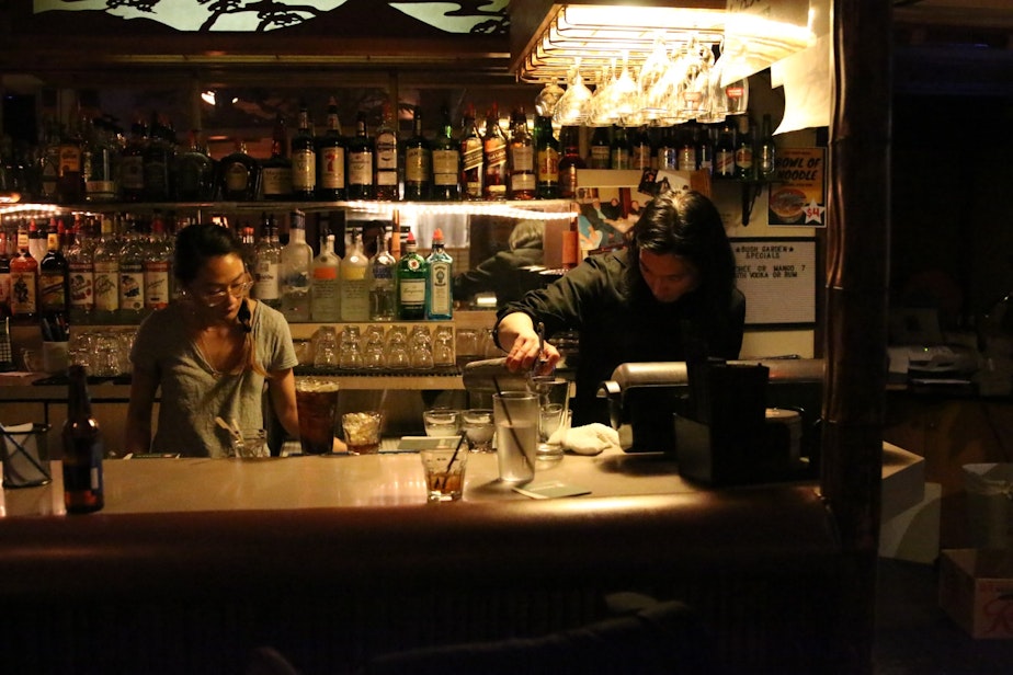 caption: Alan Sato and Sarah Moriguchi tend bar at Bush Garden
