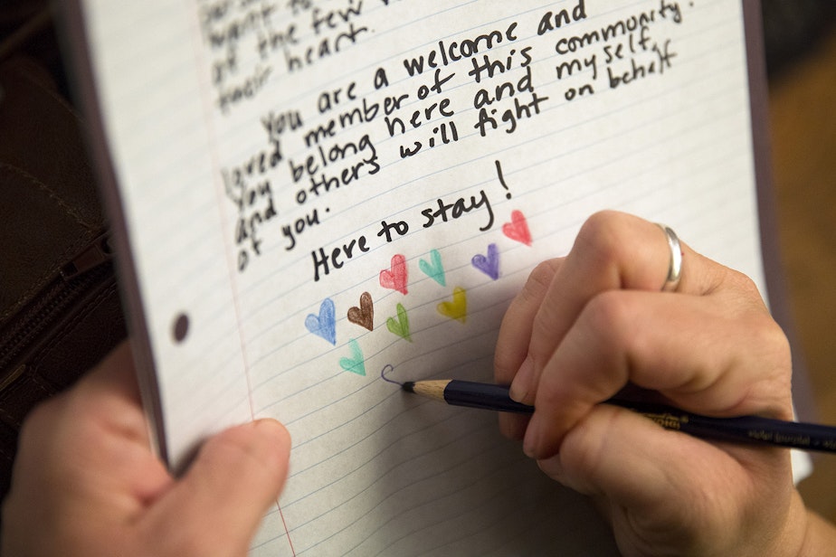 caption: Gretchen Lemon writes a letter of support on Monday, October 30, 2017, in Burien.