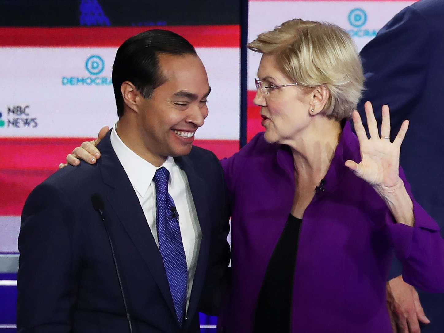 caption: Former Housing Secretary Julián Castro and Massachusetts Sen. Elizabeth Warren embrace after a Democratic presidential debate on June 26 in Miami.