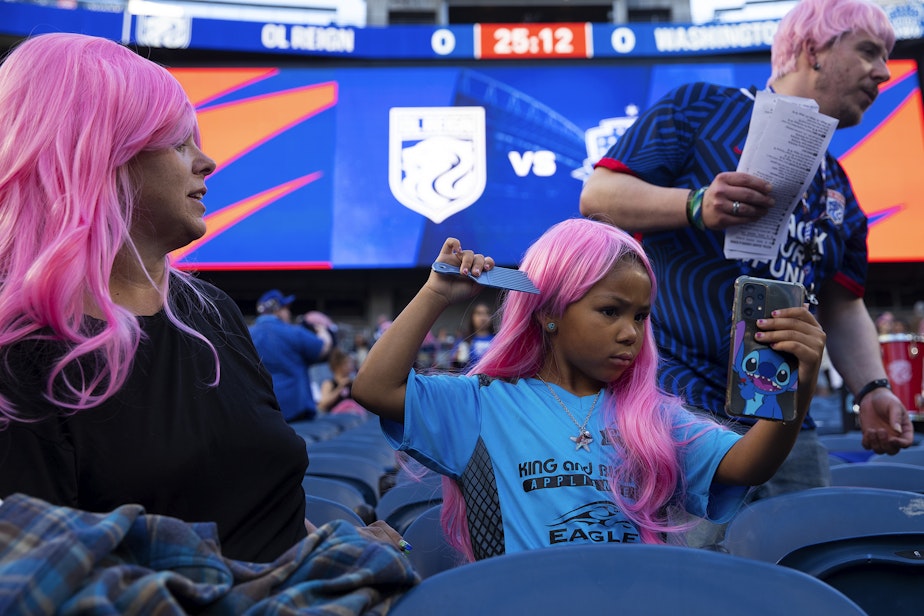 caption: Grace Skoglund, 6, checks her pink wig while attending OL Reign forward Megan Rapinoe’s last regular-season NWSL home game against the Washington Spirit on Friday, October 6, 2023, at Lumen Field in Seattle. 