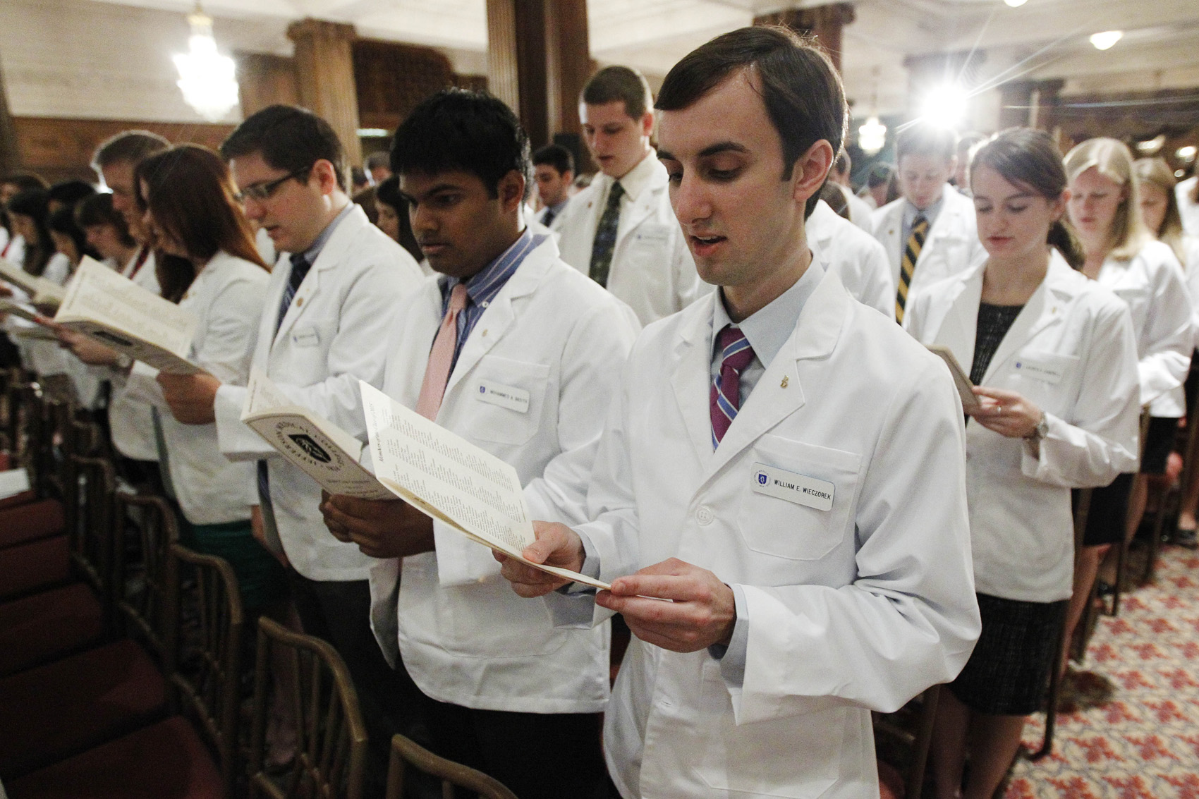 caption: Thomas Jefferson University's Jefferson Medical College first-year student William E. Wieczorek and others take the Hippocratic Oath during the annual White Coat Ceremony, Friday, Aug. 5, 2011, in Philadelphia. The ceremony symbolizes the clinical beginning of the students' medical educations. (Matt Rourke/AP)