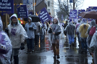 caption: Donavan Pepin, 22, an organizer with SEIU, leads a chant as nurses and caregivers strike on Tuesday, January 28, 2019, outside of the Swedish Ballard Campus along NW Market Street in Seattle.