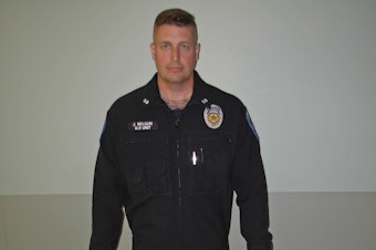 caption: In this photo provided by the Auburn Police Department via the Port of Seattle Police Department, Auburn police Officer Jeff Nelson is shown. 