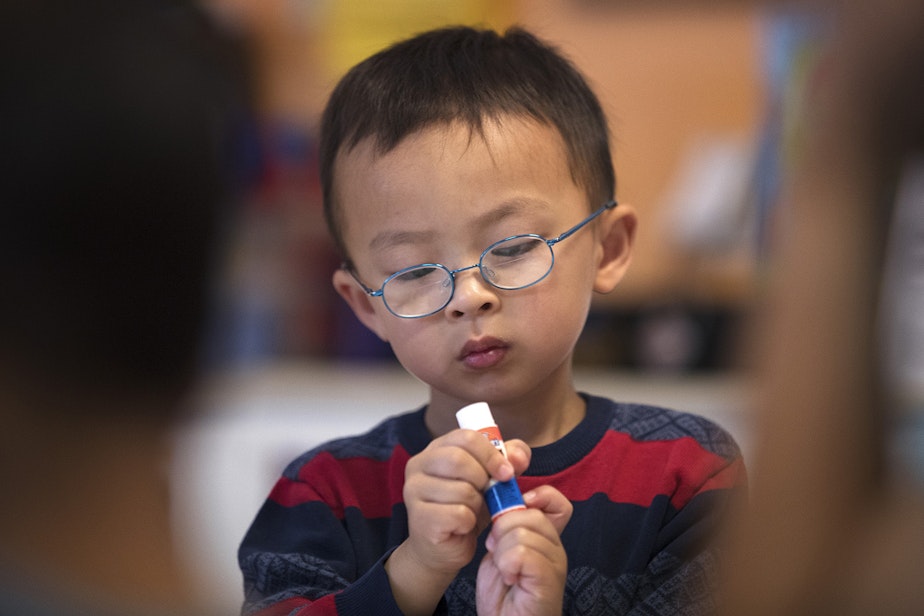 caption: Seattle Preschool Program student Jason, 5, uses glue to make crafts in teacher Hien Do's class on Wednesday, June 28, 2017, at the ReWA Early Learning Center at Beacon, in Seattle, Washington. 