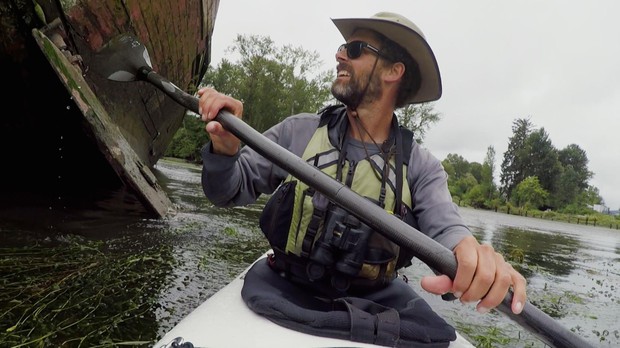 caption: <p>Andrew Emlen paddles next to the Sara Frances, a former fishing vessel abandoned along the Cathlamet Channel of the Columbia River.</p>
