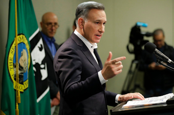 caption: King County Executive Dow Constantine talks to reporters, Wednesday, March 4, 2020, during a news conference in Seattle. 