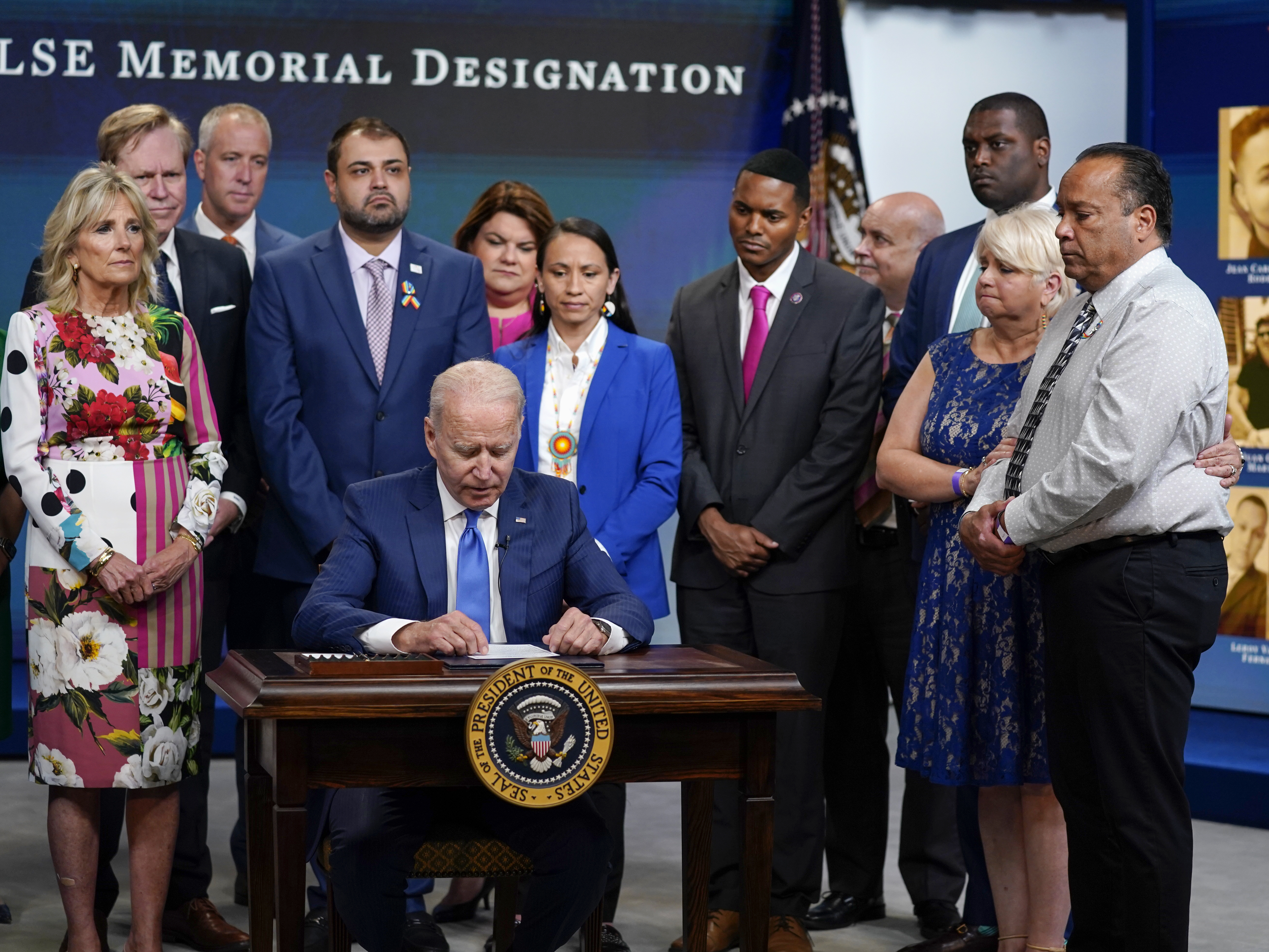 caption: President Biden prepares to sign a memorial bill Friday to recognize the victims of the 2016 Pulse nightclub shooting.