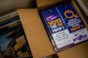 caption: Proposal 3 flyers are situated in boxes on Nov. 6, 2022, in Dearborn, Mich. Voters in Michigan passed Prop 3, enshrining the right to abortion in the state constitution.