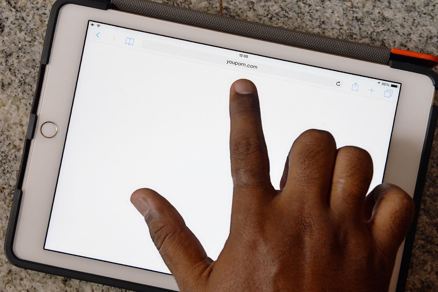 caption: An internet user points out at a porn site showing a blank screen, August 3, 2015. (Manjunath Kiran/AFP/Getty Images)