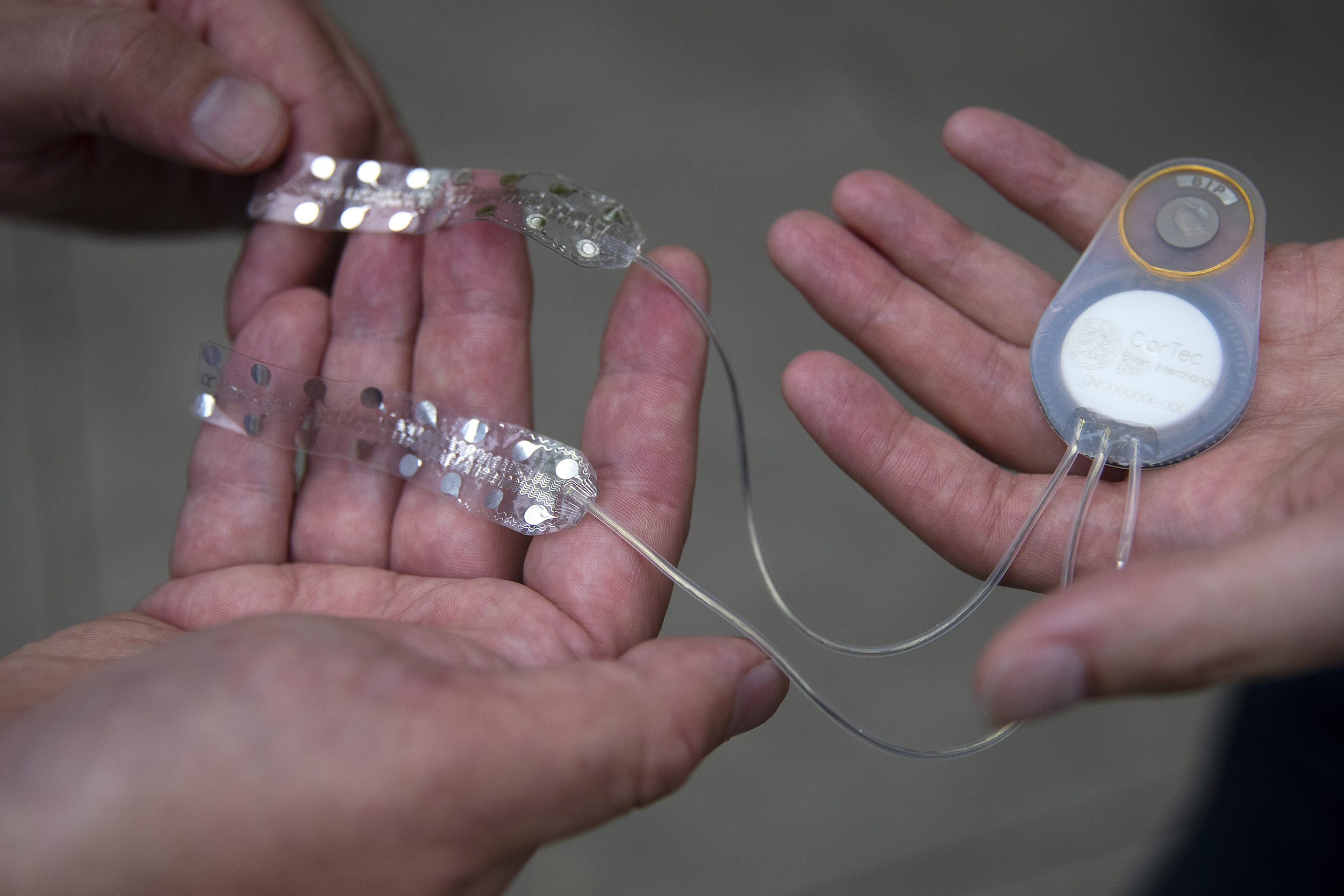 caption: Dr. Jeffrey Ojemann, left, and Dr. Jeffrey Herron, right, handle the CorTec Brain Interchange, a device they hope will help stroke victims recover lost function, on Tuesday, August 19, 2025, on the University of Washington campus in Seattle. 