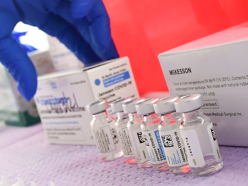 caption: Bottles of the single-dose Johnson & Johnson Janssen COVID-19 vaccine await transfer into syringes for administering in March in Los Angeles. The CDC had called on Tuesday for a pause in administering the vaccine.
