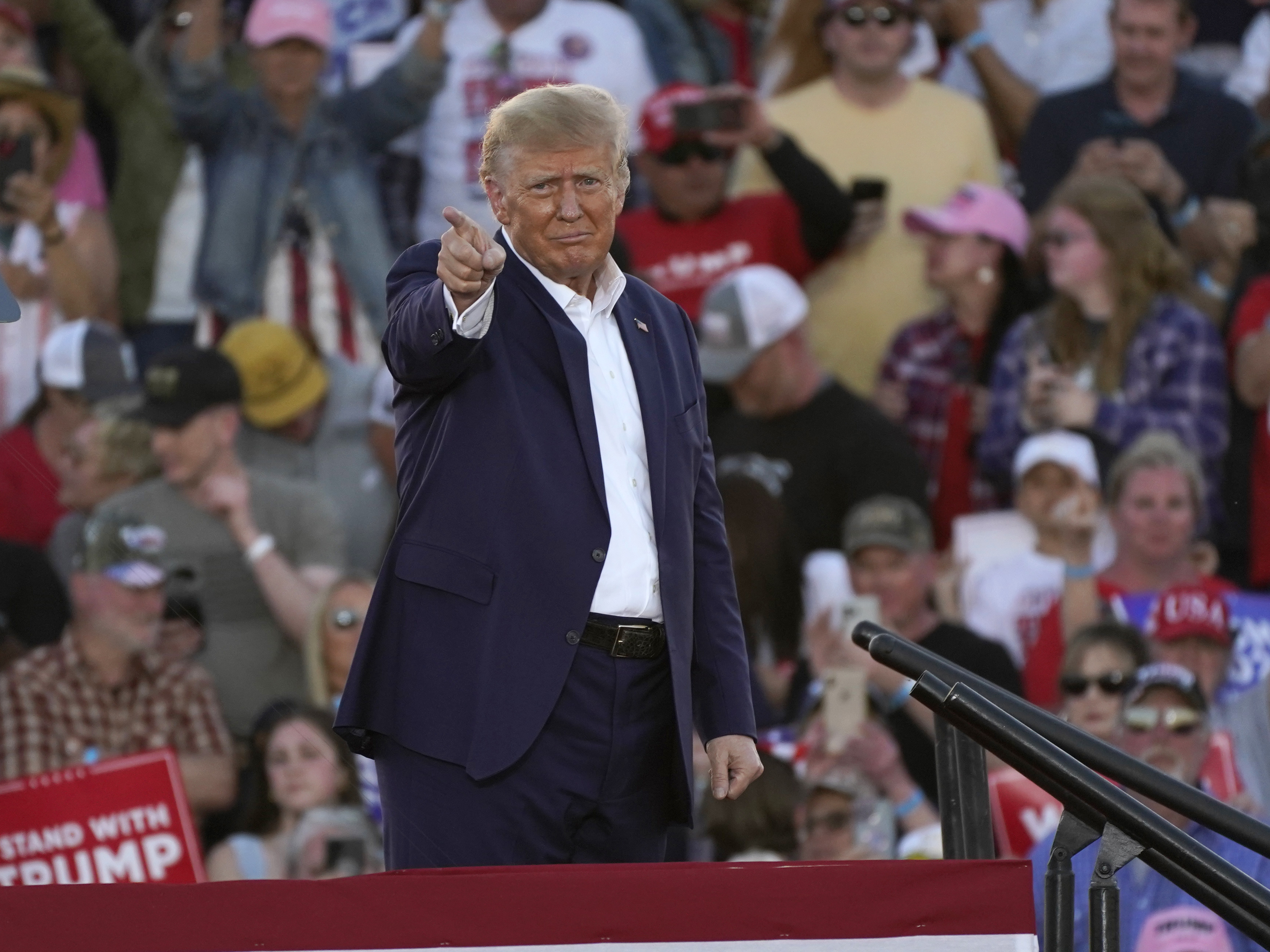caption: Former President Donald Trump gestures to supporters after speaking at a campaign rally at Waco Regional Airport on Saturday in Waco, Texas.
