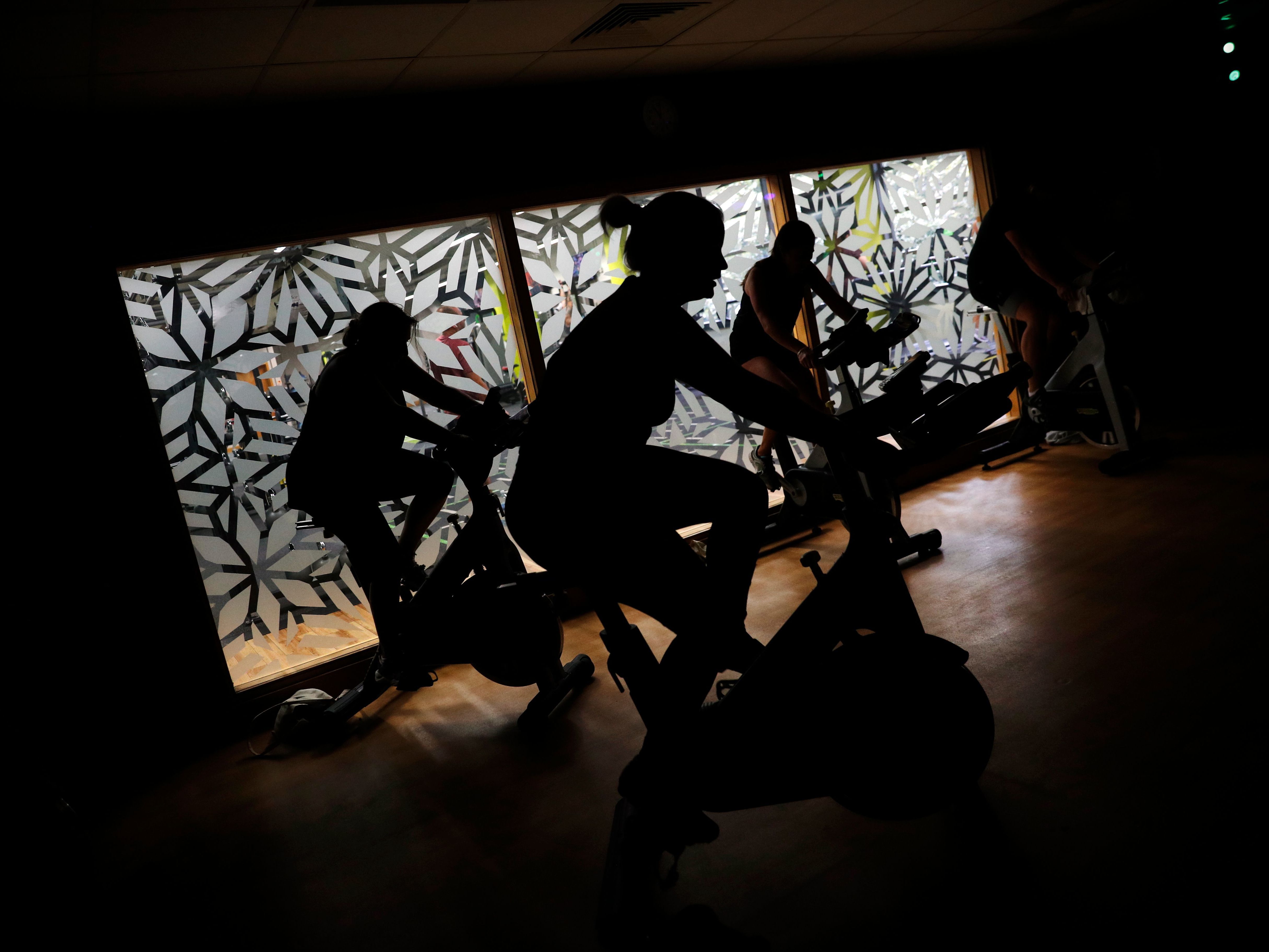 caption: People are working out in the shadows.