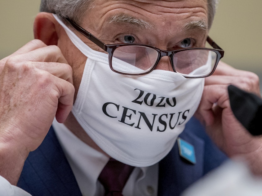 caption: Census Bureau Director Steven Dillingham, wearing a face covering printed with the words "2020 Census," testified before the House oversight committee Wednesday that the bureau plans to finish counting "as soon as possible" despite career officials previously saying they need until Oct. 31 to finish a complete national head count.