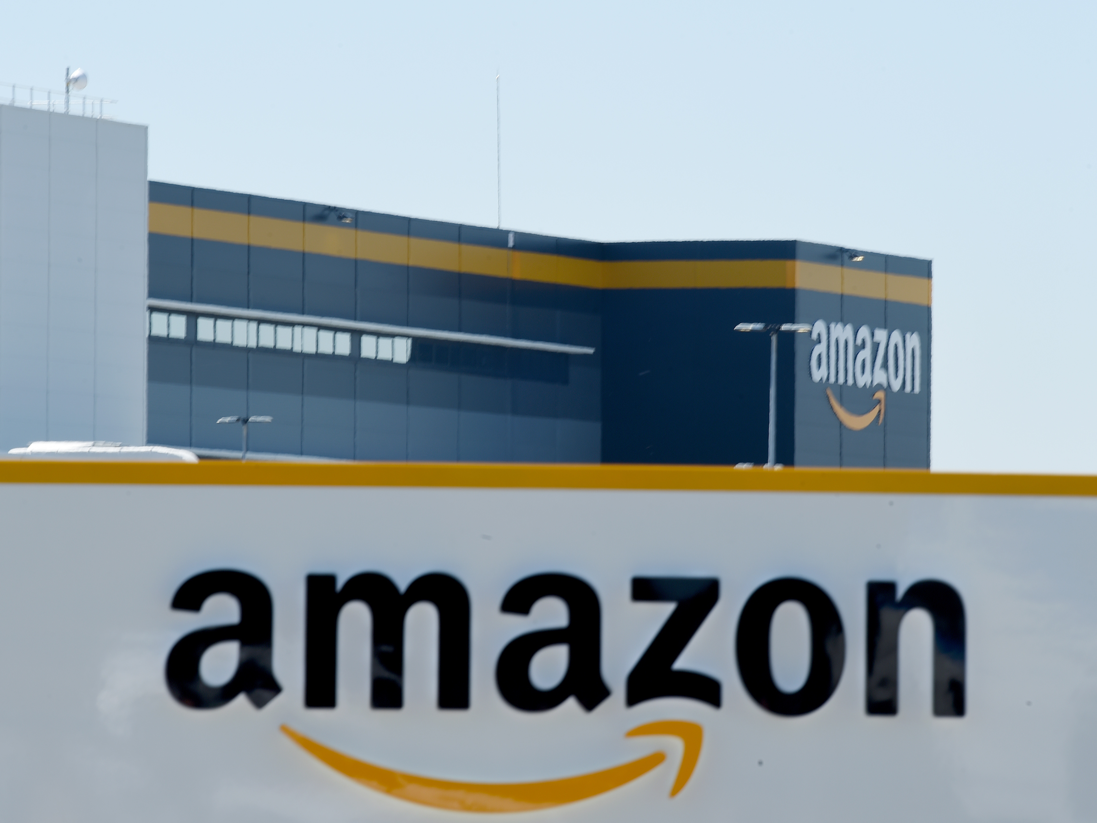 caption: Amazon's logo appears on a warehouse in France, on May 19.