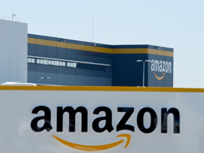 caption: Amazon's logo appears on a warehouse in France, on May 19.