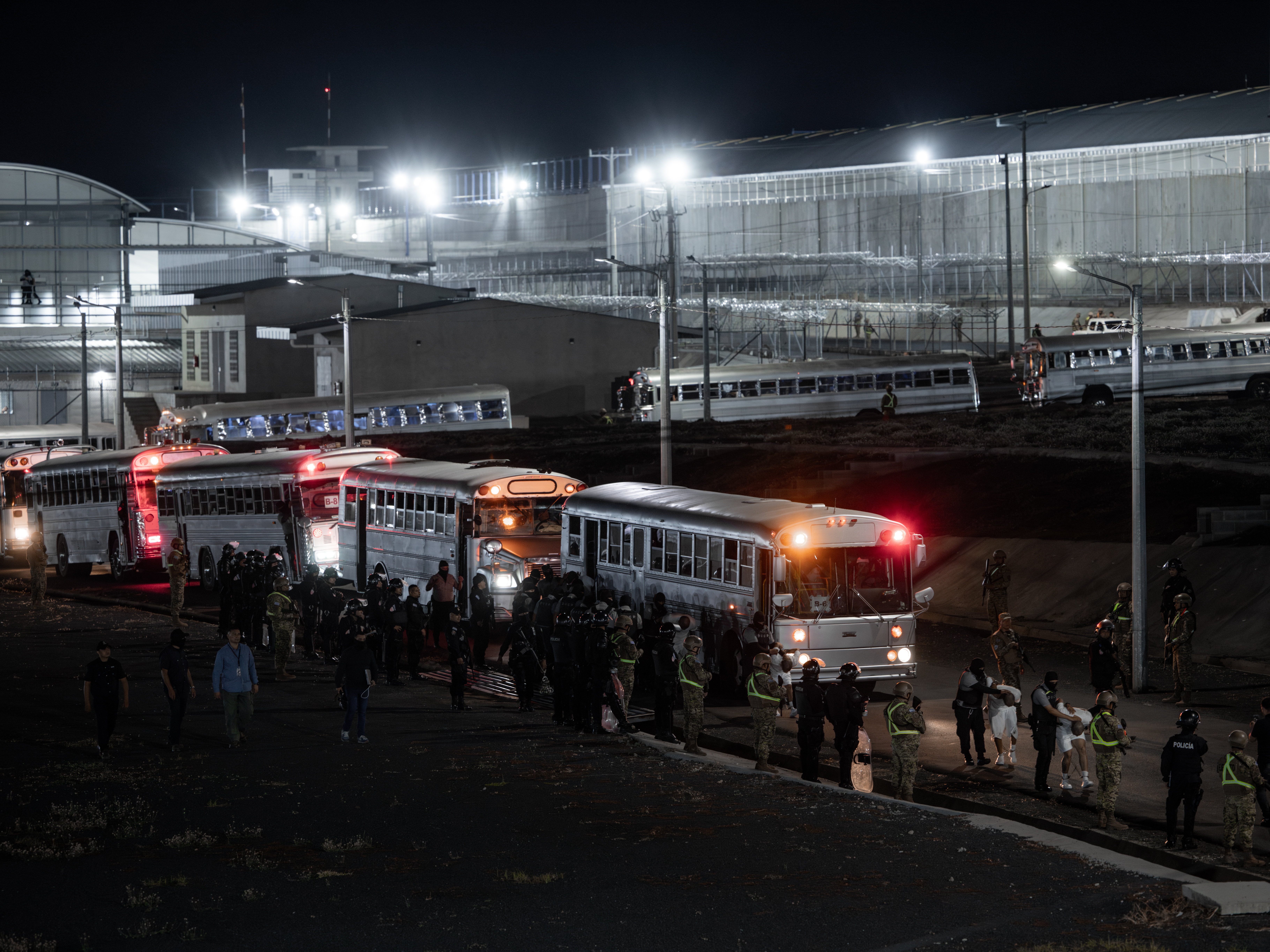 caption: More than 250 people the U.S. government says are foreign gang members arrived in El Salvador by plane on March 16, where El Salvador's President Nayib Bukele confirmed they will be sent to the country's mega-prison CECOT.