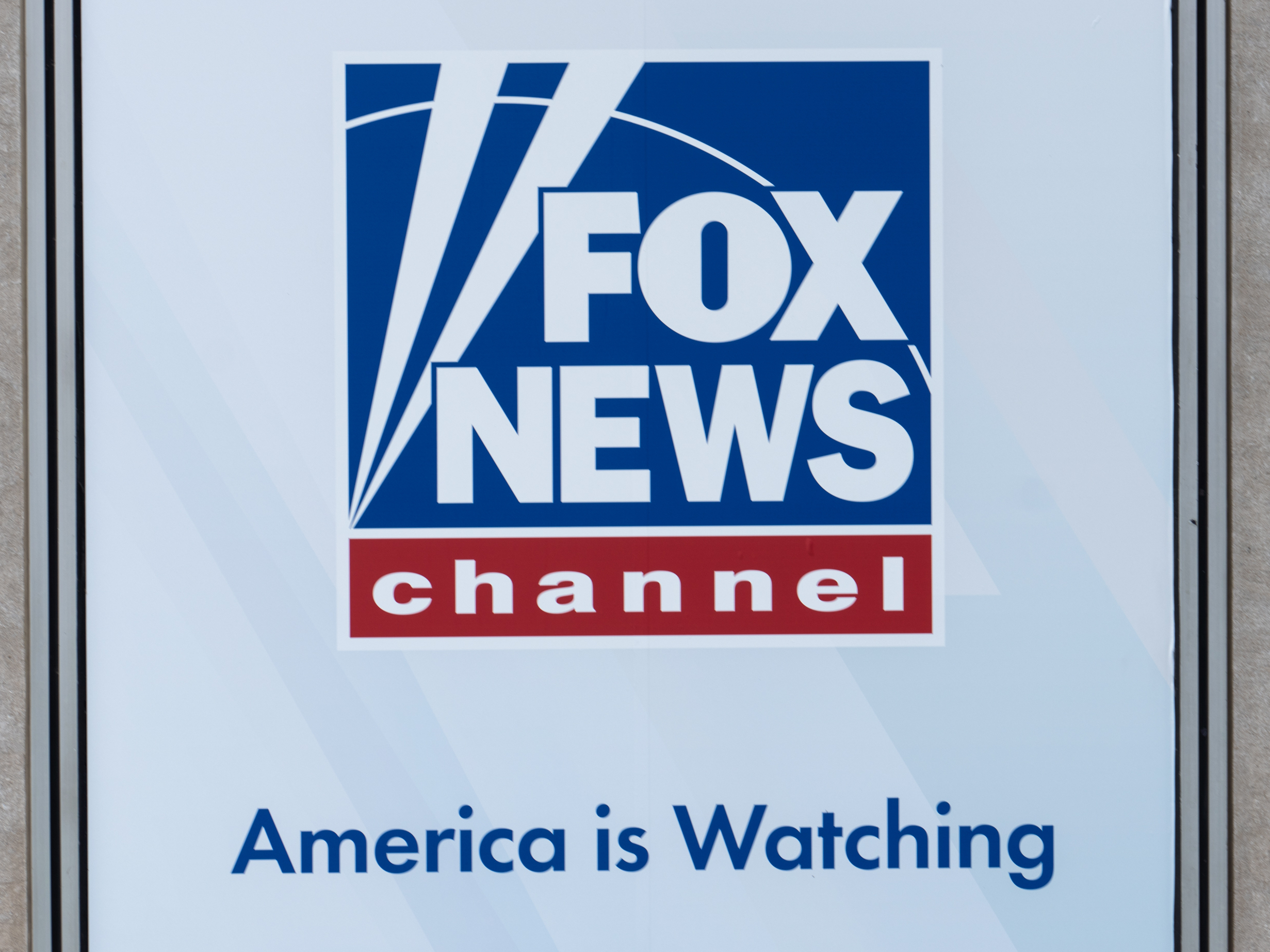 caption: A banner displayed in April at the Fox News headquarters in New York.