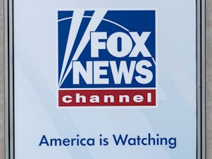 caption: A banner displayed in April at the Fox News headquarters in New York.