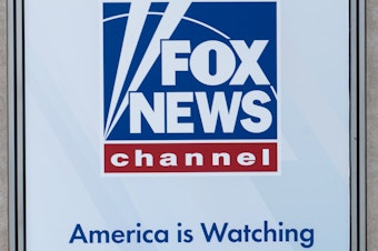 caption: A banner displayed in April at the Fox News headquarters in New York.