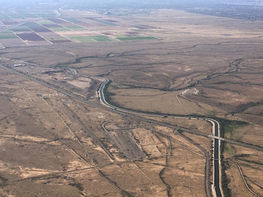 caption: In this Oct. 8, 2019, file photo, the Central Arizona Project canal runs through rural desert near Phoenix. The canal diverts Colorado River water down a 336-mile long system of aqueducts, tunnels, pumping plants and pipelines to the state of Arizona.