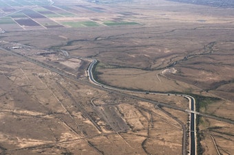 caption: In this Oct. 8, 2019, file photo, the Central Arizona Project canal runs through rural desert near Phoenix. The canal diverts Colorado River water down a 336-mile long system of aqueducts, tunnels, pumping plants and pipelines to the state of Arizona.
