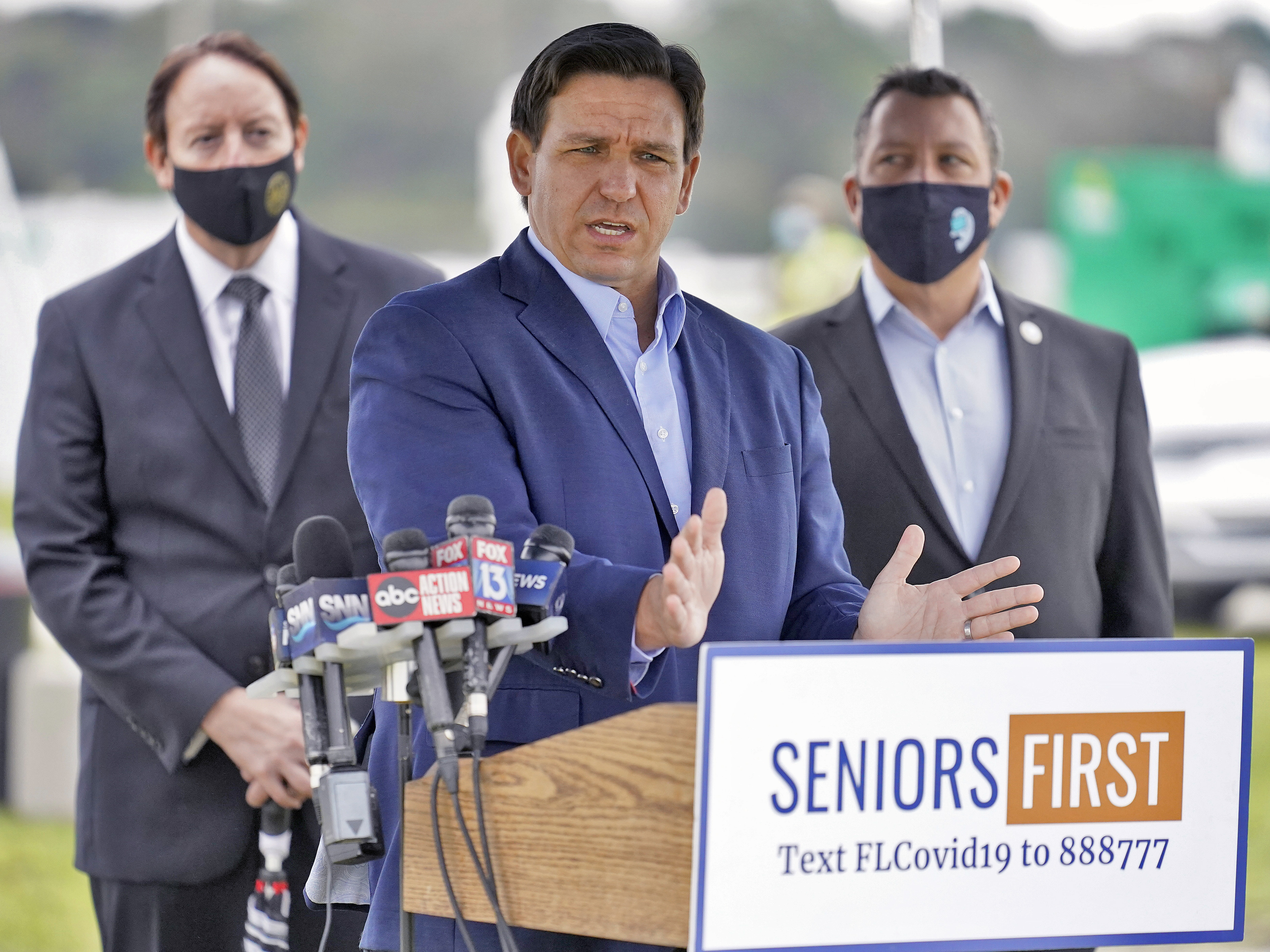 caption: Florida Gov. Ron DeSantis speaks to the media at a COVID-19 vaccination site near the upscale Lakewood Ranch community in Bradenton, Fla., on Wednesday.