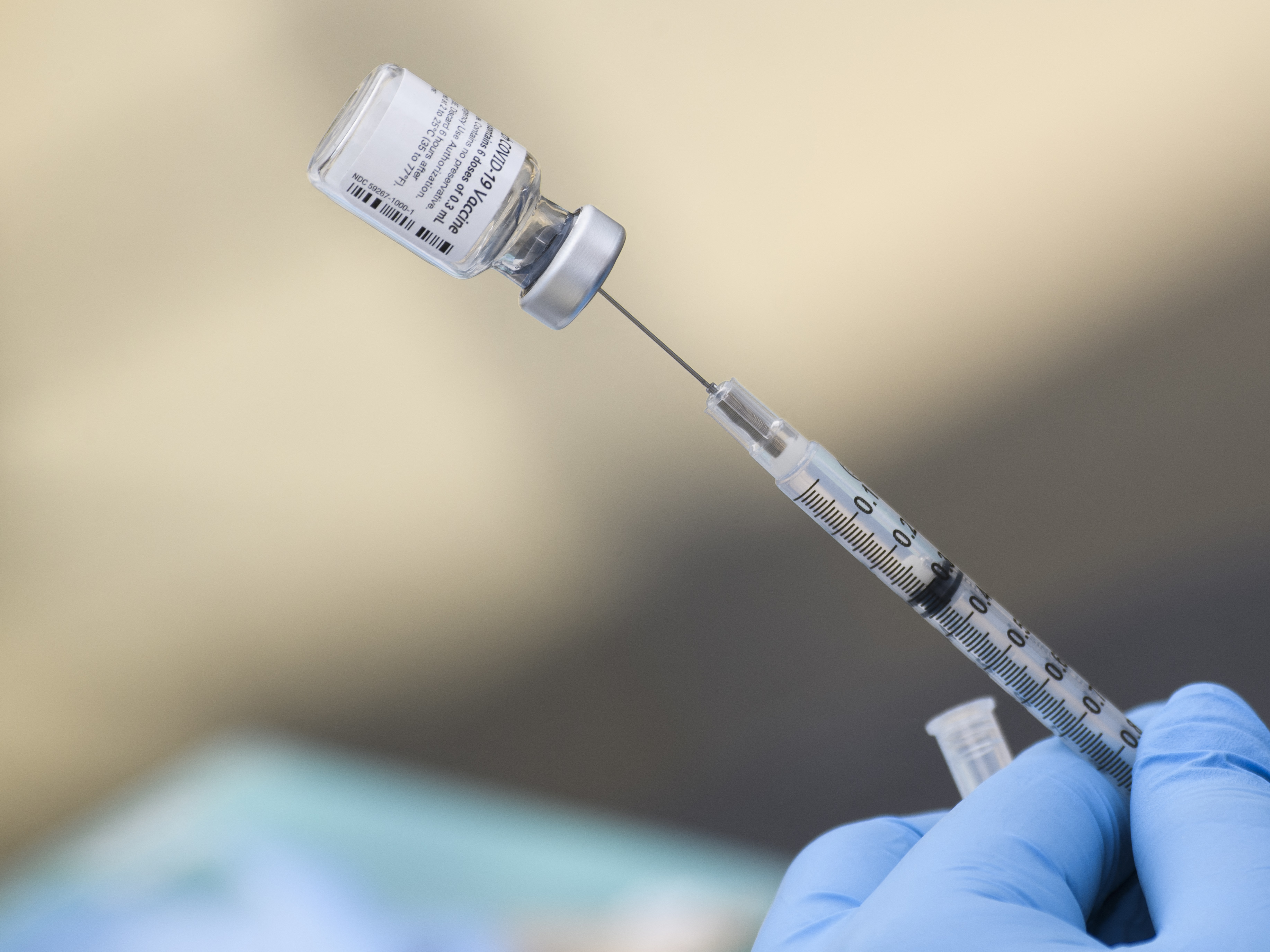 caption: A syringe is filled with a dose of the Pfizer-BioNTech COVID-19 vaccine. While the vaccine has now been authorized for children between ages 5 and 11, it may take several weeks for shots to become widely available.