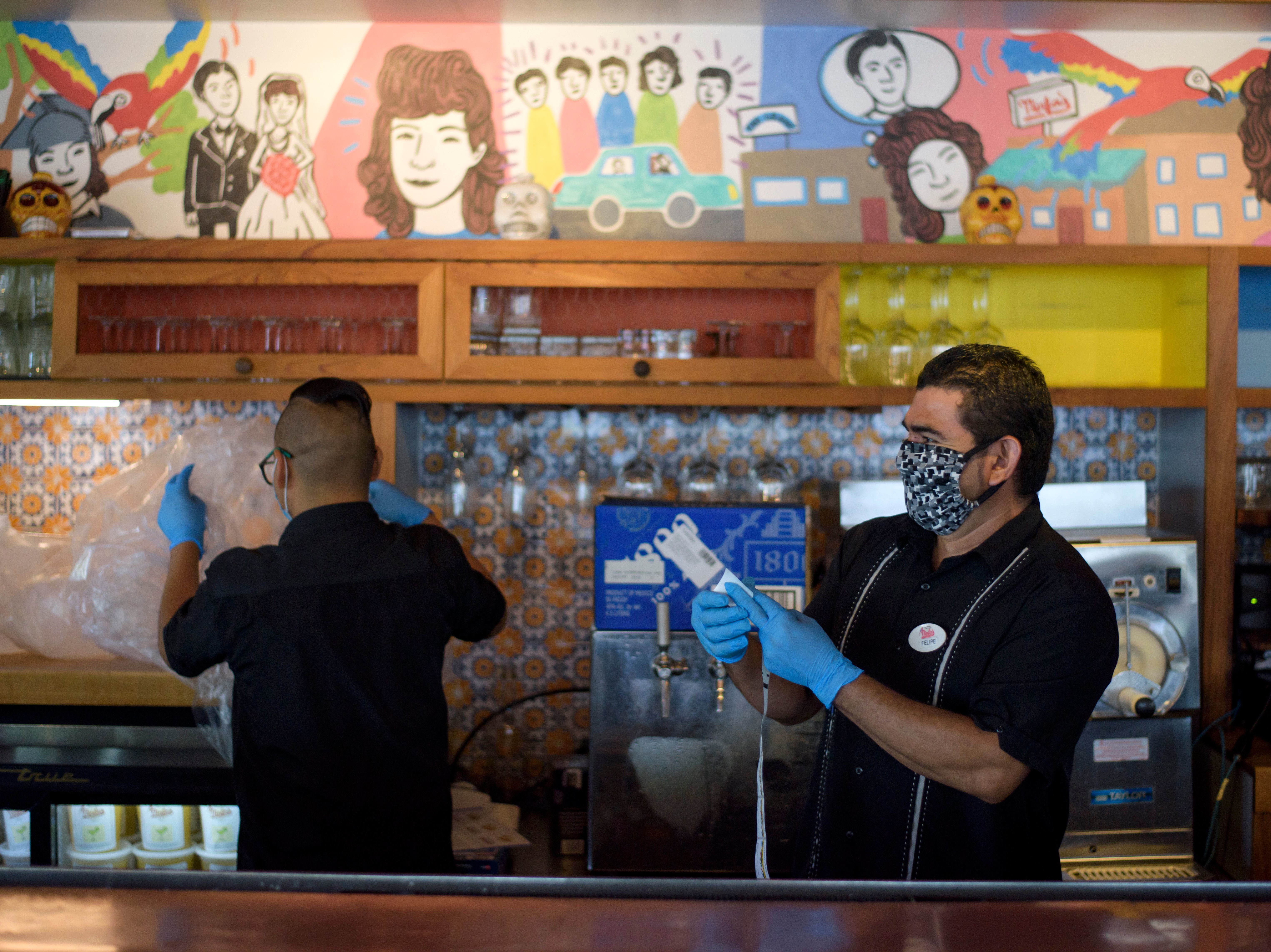 caption: Workers prepare takeout orders in Houston on May 1. For more than two out of three unemployed workers, jobless benefits exceed their old pay, researchers say. That can raise awkward questions for workers, bosses and policymakers.