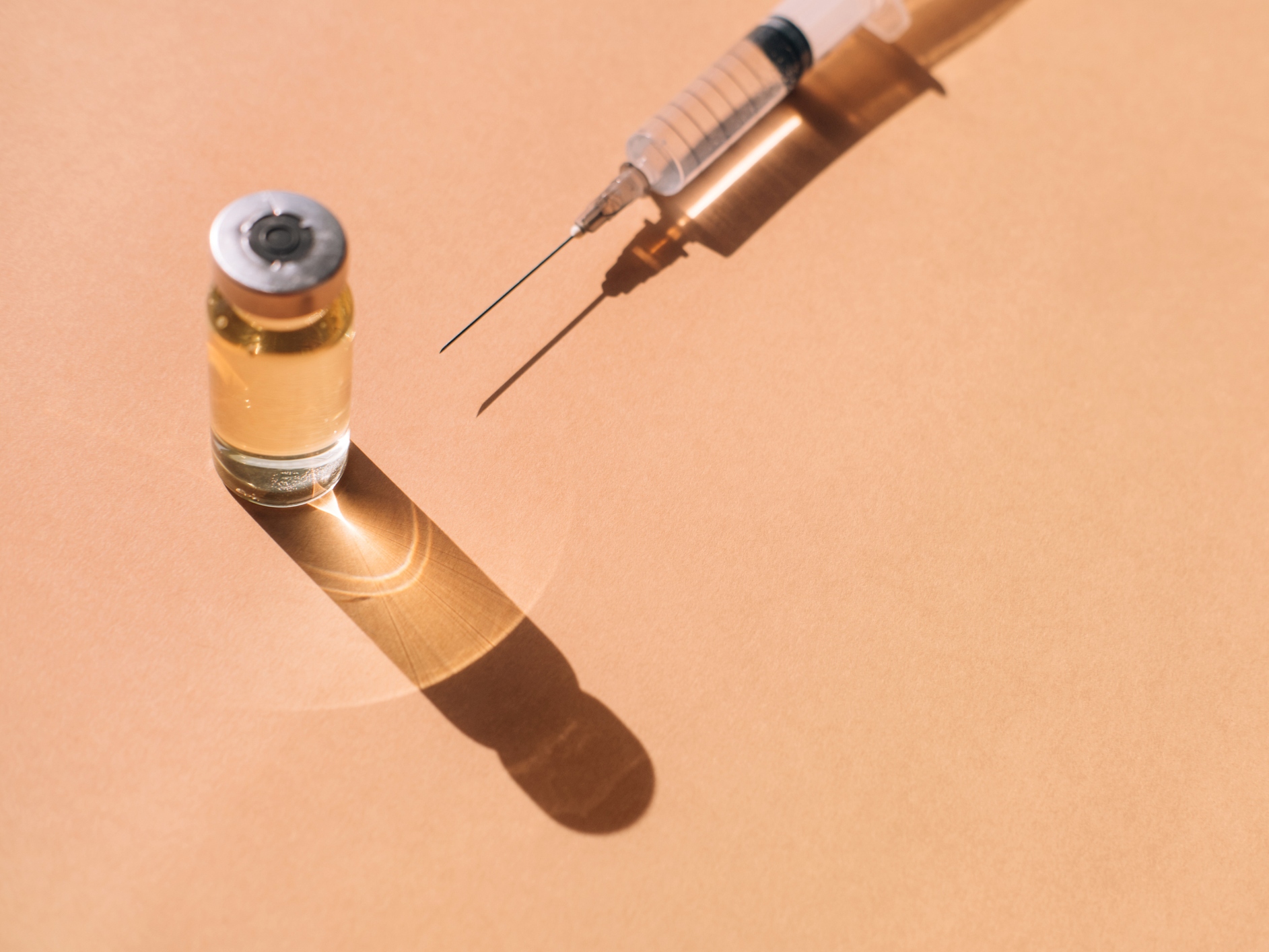 Clean syringe and sealed bottle of medication