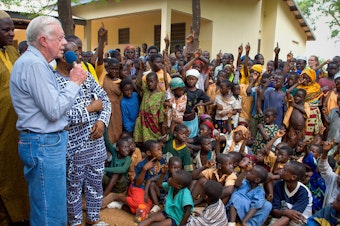 caption: On a 2007 visit to Savelugu Hospital in Ghana, President Jimmy Carter asks a group of children if they've had Guinea worm. A raised hand is a yes.
