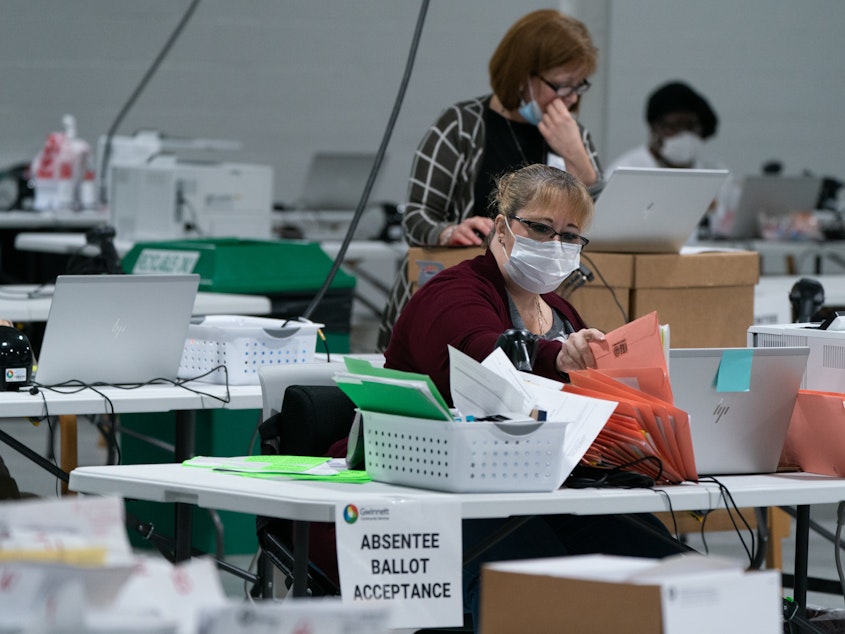 caption: Election personnel sort ballots in preparation for an audit at the Gwinnett County Board of Voter Registrations and Elections offices on November 7, 2020 in Lawrenceville, Ga. President Trump's attempt at legal action to contest the results of the election have so far been mostly unsuccessful.