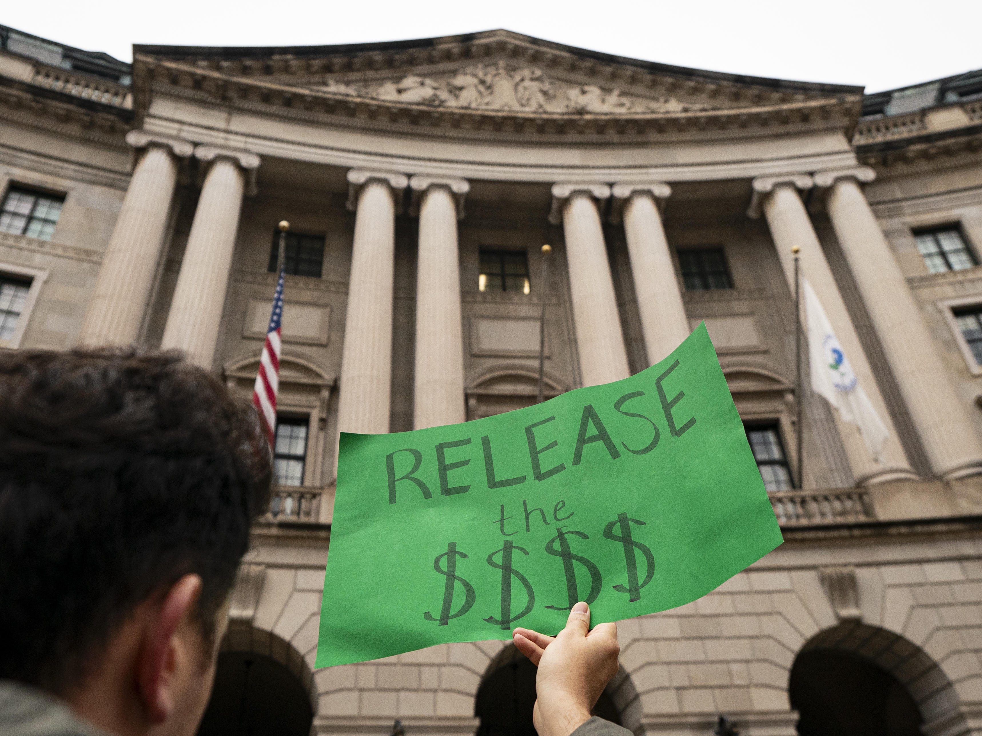 caption: A demonstrator shows opposition during a demonstration at the Environmental Protection Agency on Feb. 6 in Washington, DC.