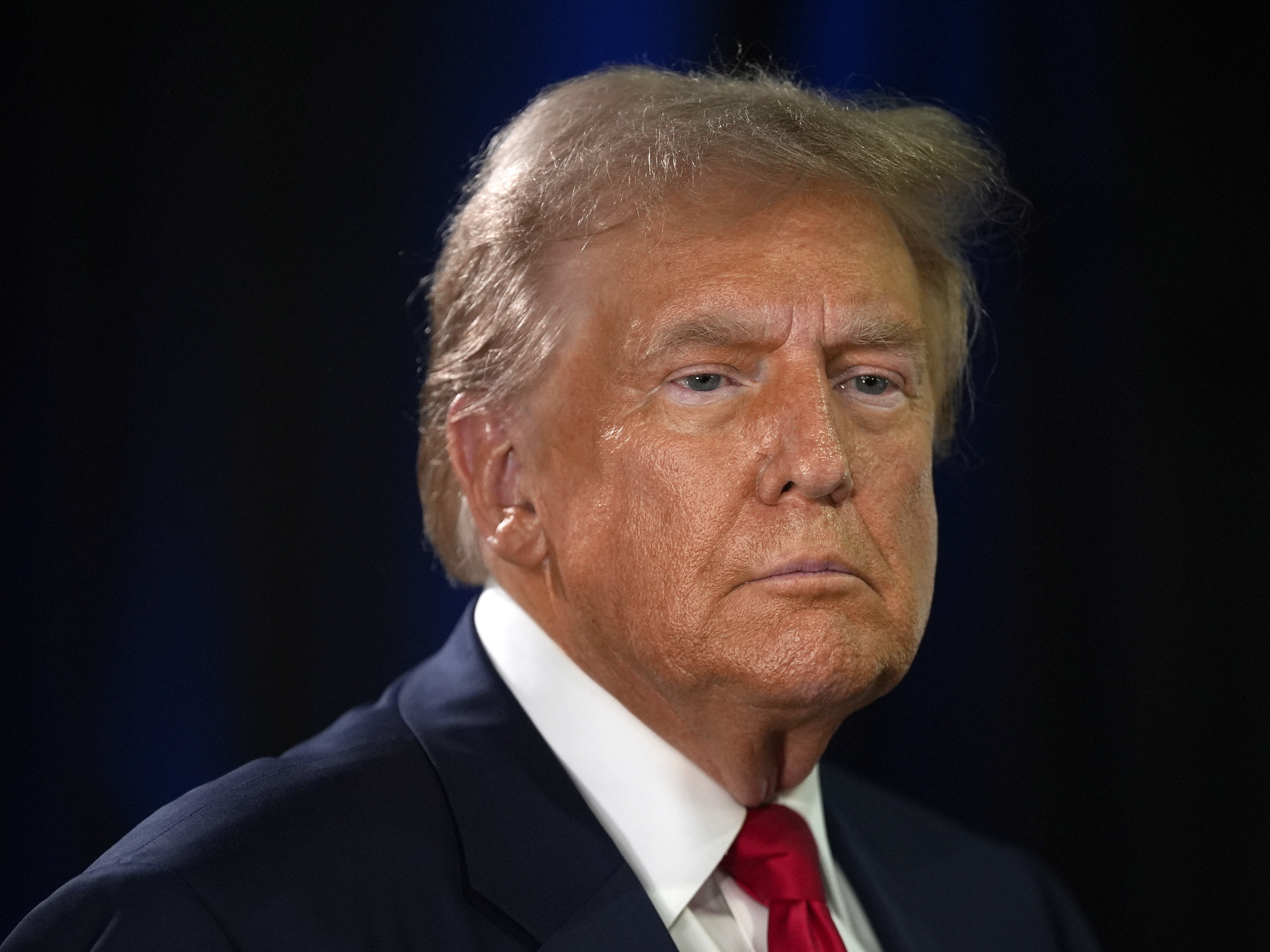 caption: Republican presidential nominee former President Donald Trump speaks to reporters in the spin room after a presidential debate with Democratic presidential nominee Vice President Harris on Sept. 10 in Philadelphia. 