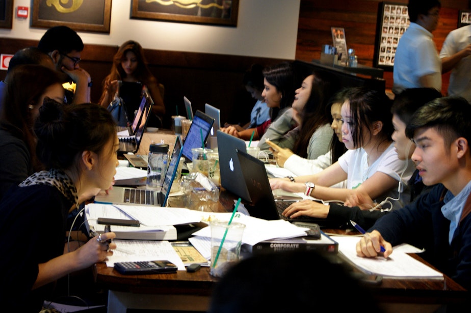caption: Students study in a Singapore Starbucks.
