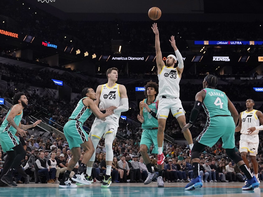 caption: Utah Jazz guard Johnny Juzang (33) shoots against the Spurs during a game in San Antonio on Wednesday.