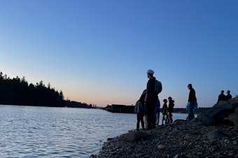caption: Visitors look for bats at Woodard Bay Natural Resources Conservation Area near Olympia on June 3, 2023.