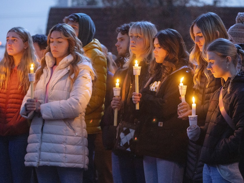 caption: Boise State University students, along with people who knew the four University of Idaho students who were found killed in Moscow, Idaho, in November, pay their respects at a vigil on November 17.