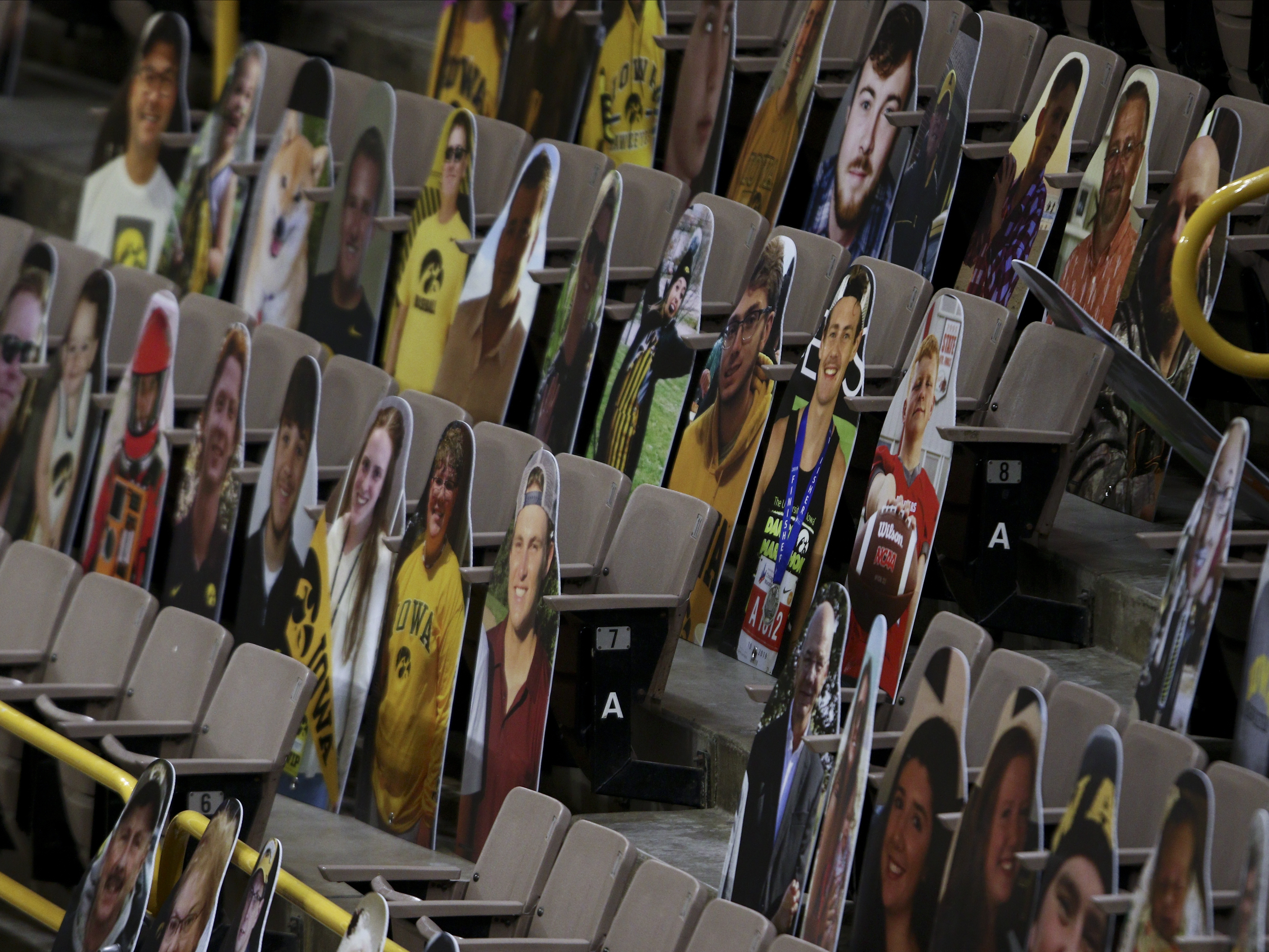 caption: The NCAA says it hasn't decided on whether any fans will be allowed to watch the men's basketball tournament, which will center on Indianapolis. Here, cardboard placards populate Iowa's Carver-Hawkeye Arena last month.