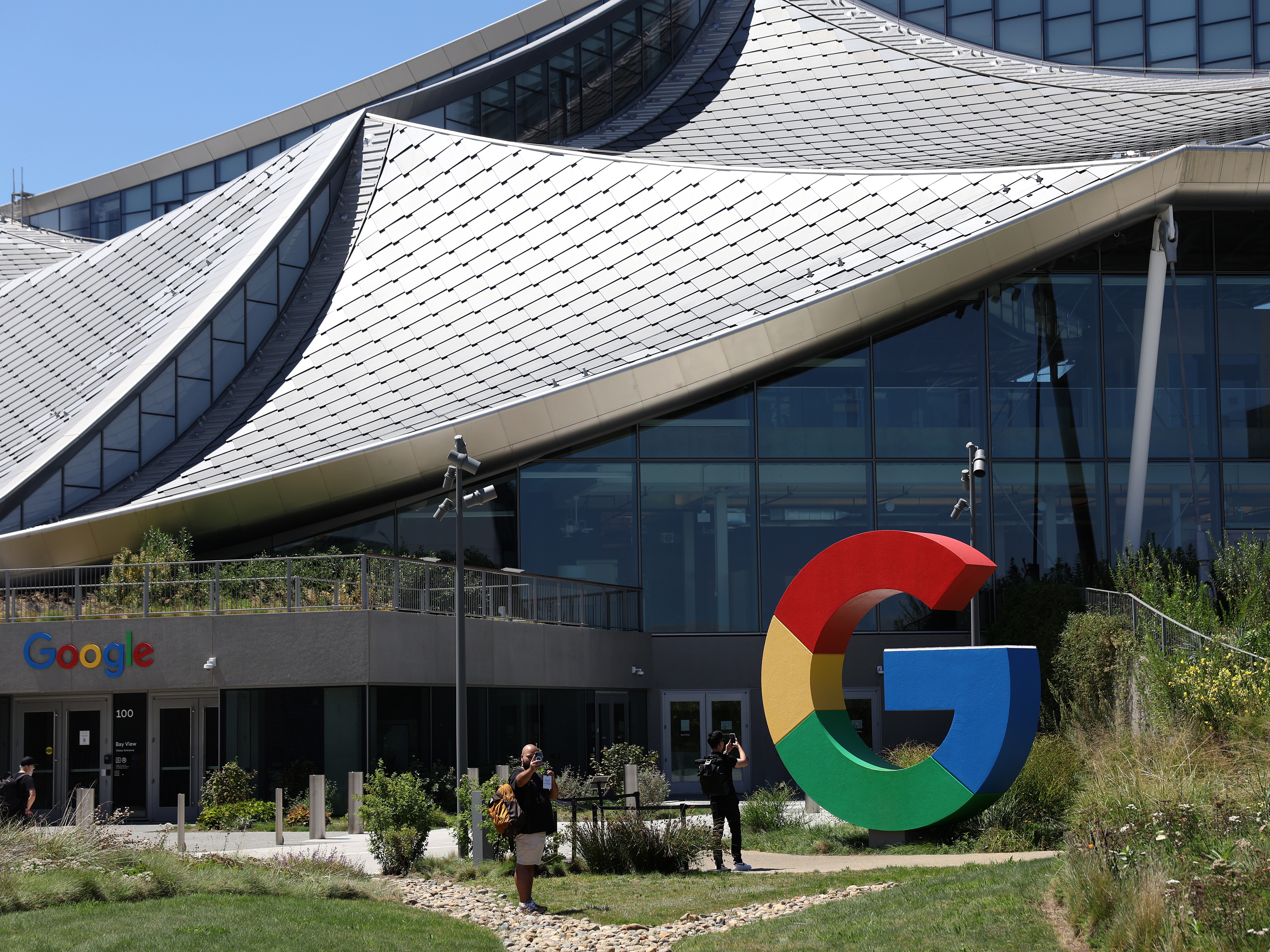 caption: MOUNTAIN VIEW, CALIFORNIA - AUGUST 13: The Google logo is displayed in front of company headquarters during the Made By Google event on August 13, 2024 in Mountain View, California.