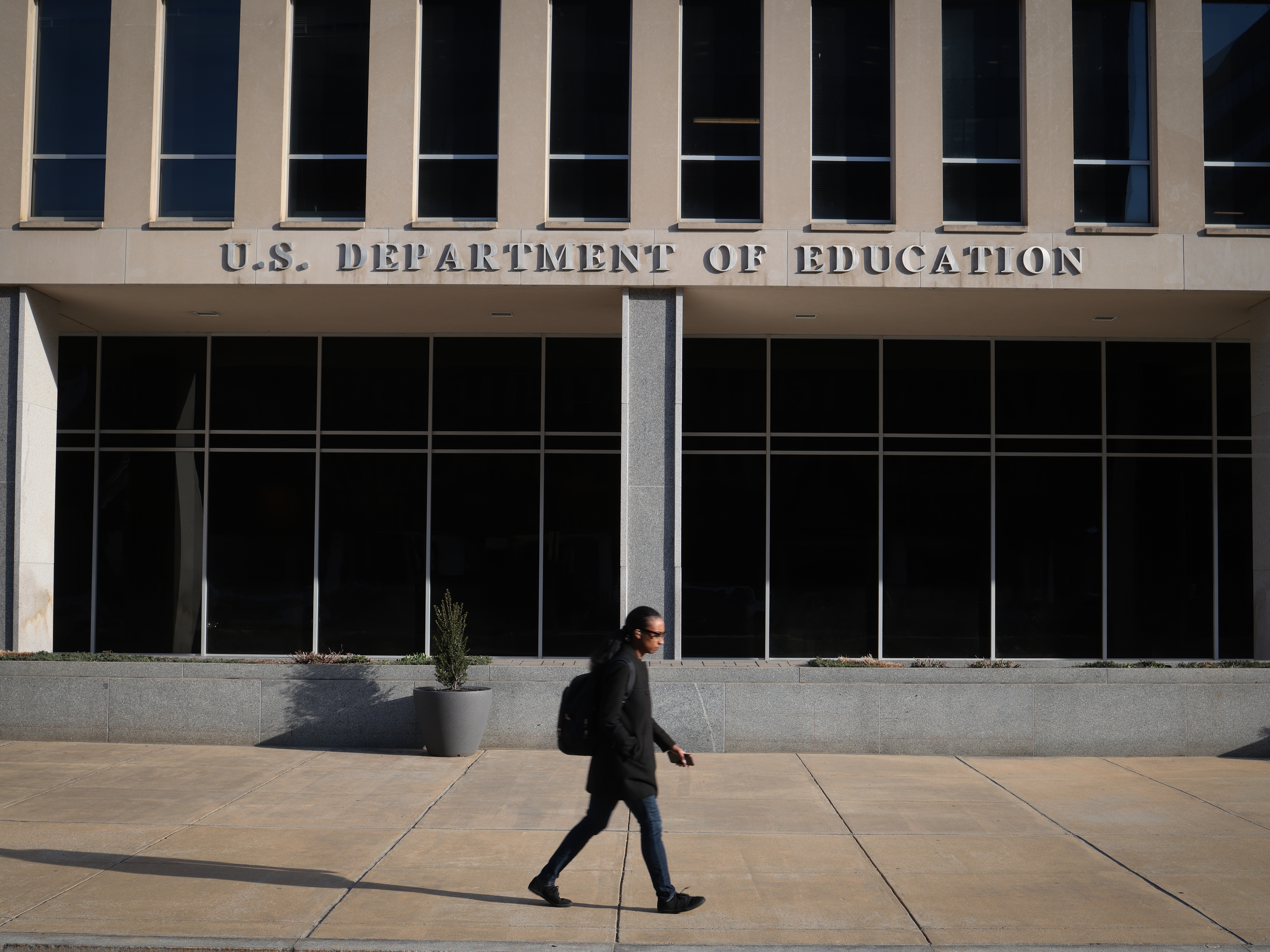 caption: The Washington headquarters of the Department of Education on March 12. A federal judge ruled that the Trump administration violated the First Amendment rights of Education Department employees when it replaced their personalized out-of-office notifications with partisan language.