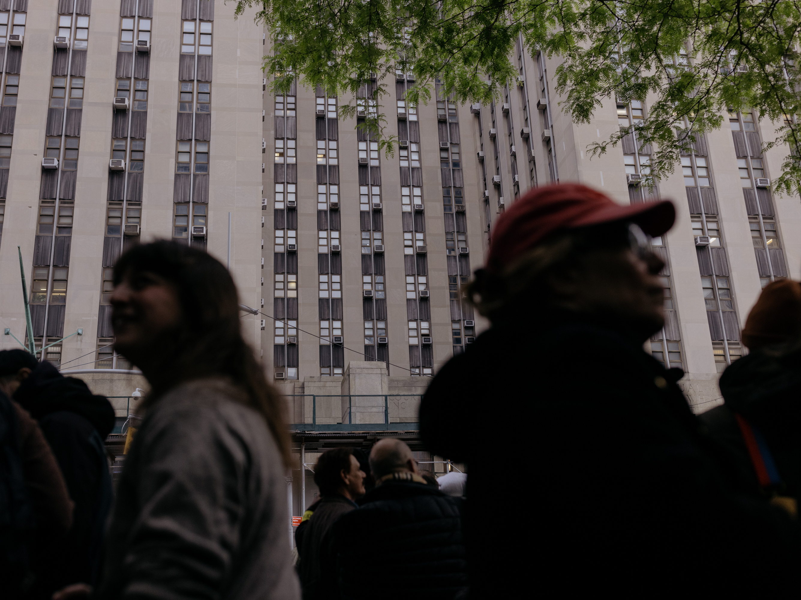 caption: A line forms Monday outside the courthouse for a chance to sit in on the 16th day of former President Trump's hush-money trial in Manhattan, N.Y.